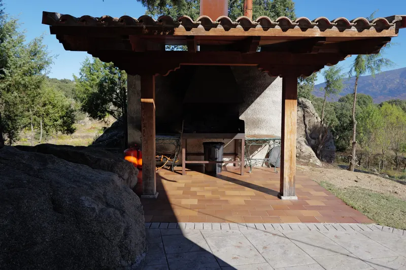 Barbacoa cubierta de piedra, con la sierra al fondo